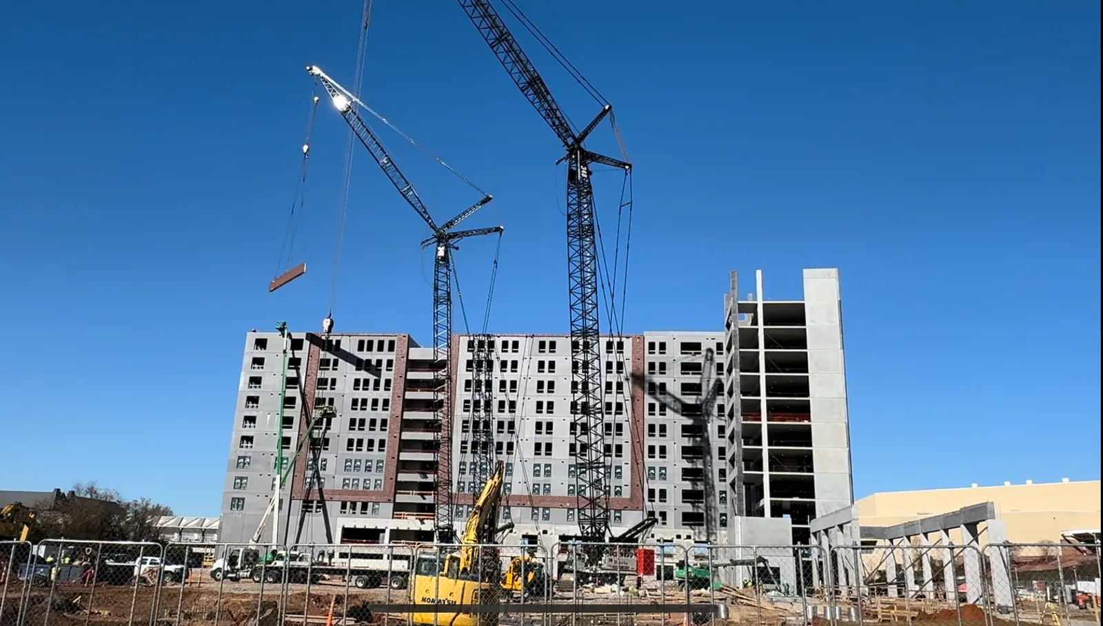 Large multi-story commercial construction project with tower cranes